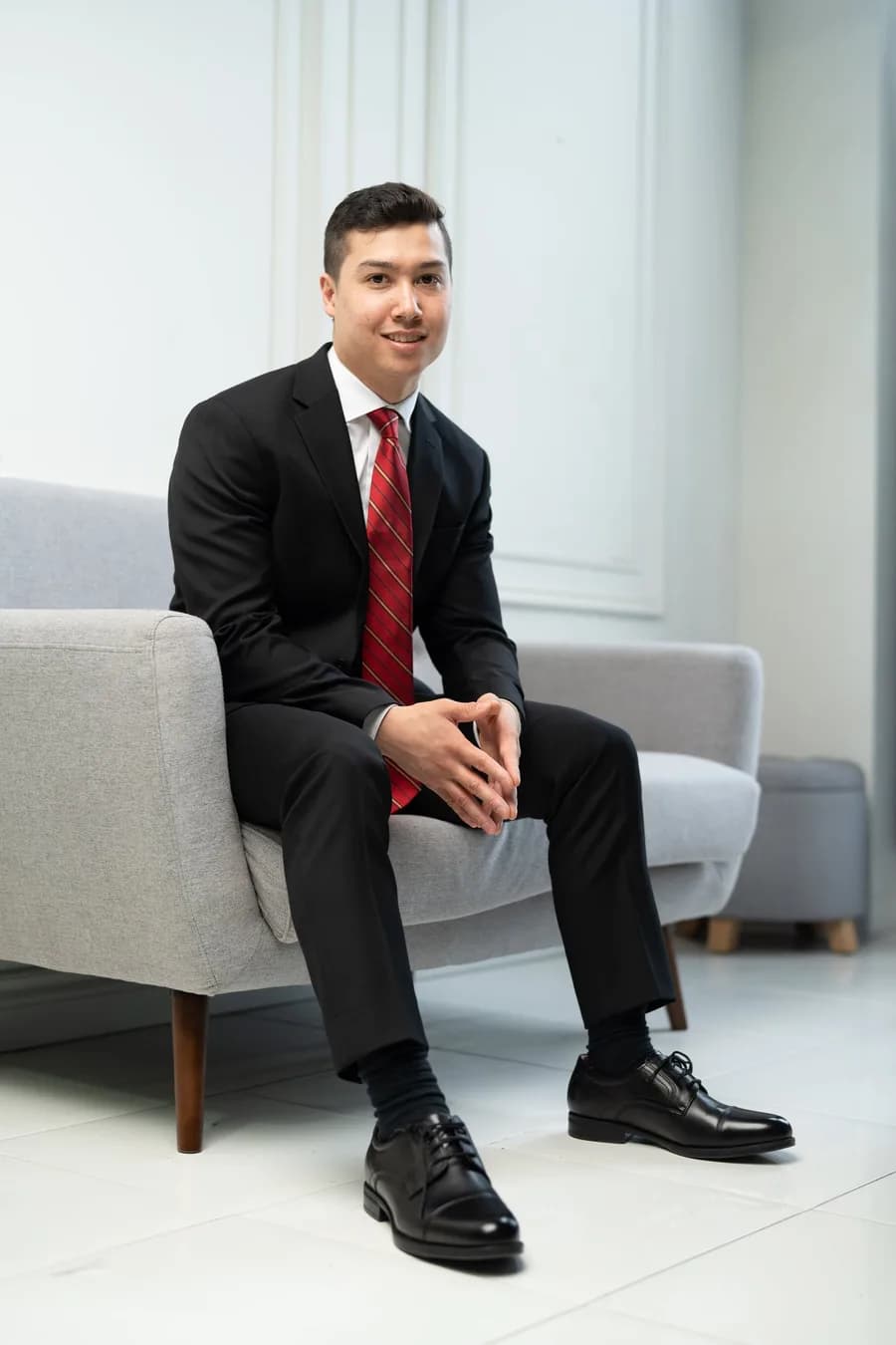 Justin Cheung seated in a relaxed editorial portrait